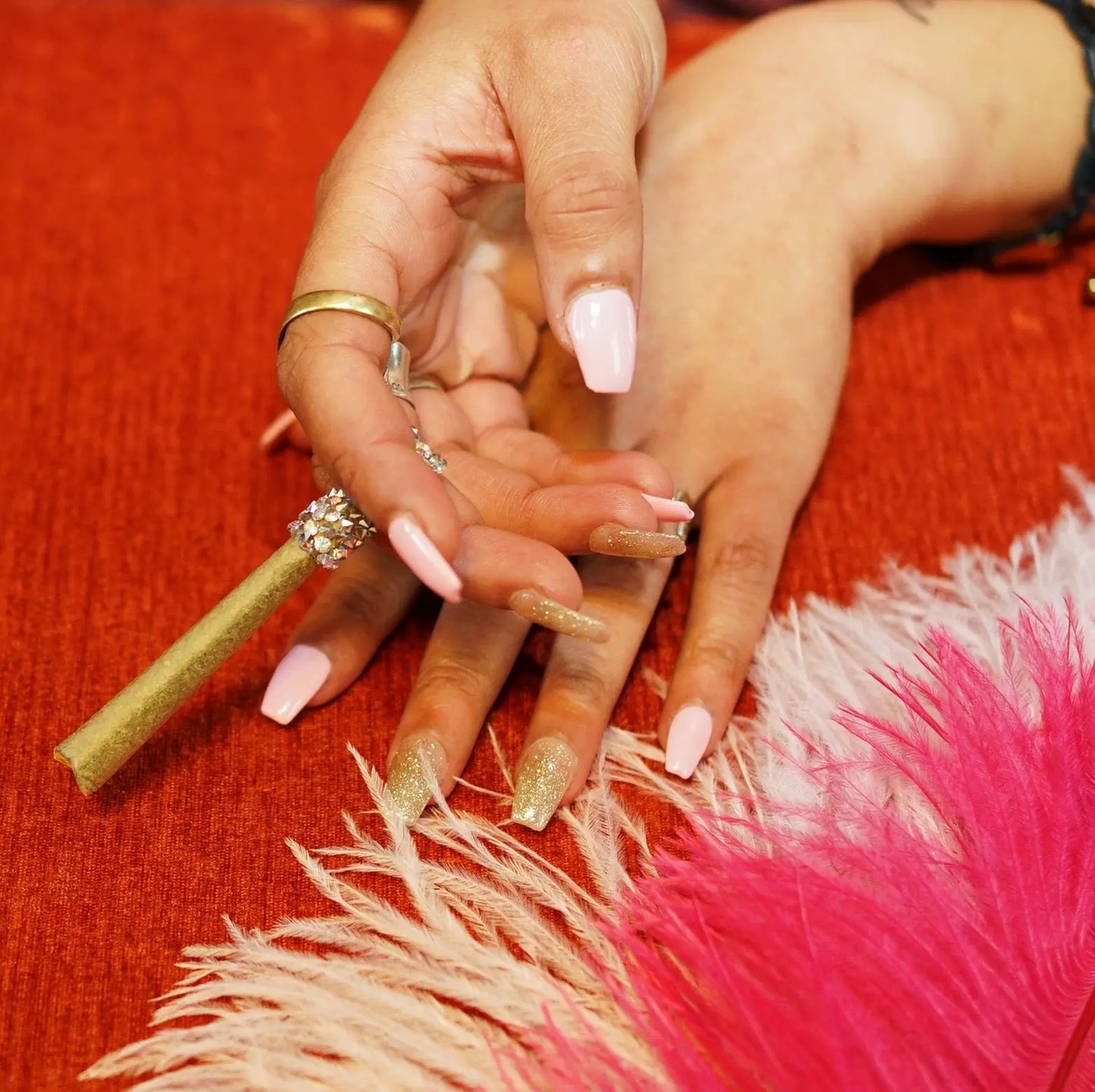 Bedazzled CBD Hemp Joint Flower Rhinestone Dress up Nails Acrylic Black Hands Pink Feathers Rings Gold Sparkles Silver
